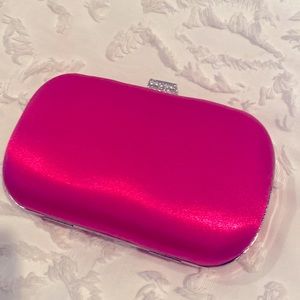 New with tags PINK SATIN clutch. Never used.